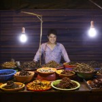 Kevin Longa standing behind the edible insect street stand